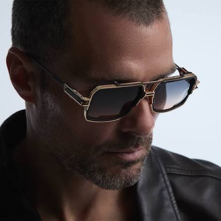 A man in gold aviator sunglasses