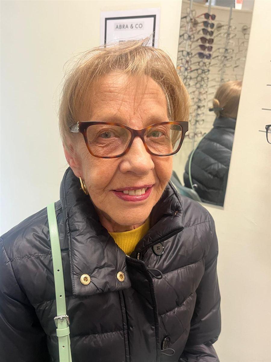 A patient in tortoiseshell glasses, chosen at Abra & Co