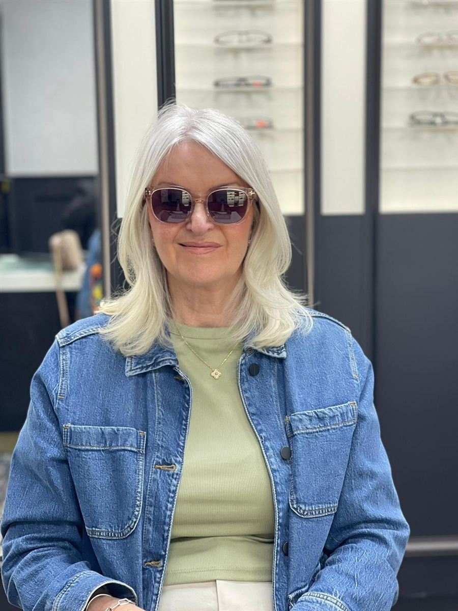 A patient with silver hair in tinted sunglasses and a denim jacket, chosen at Abra & Co