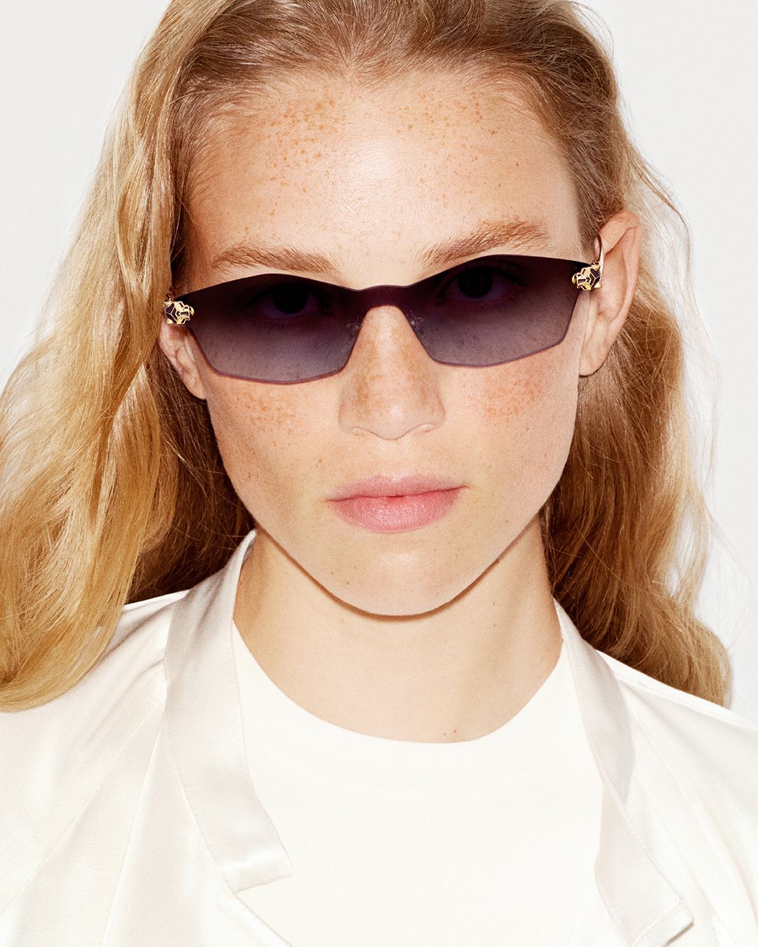 Model in rimless Cartier Panthère sunglasses and a white shirt