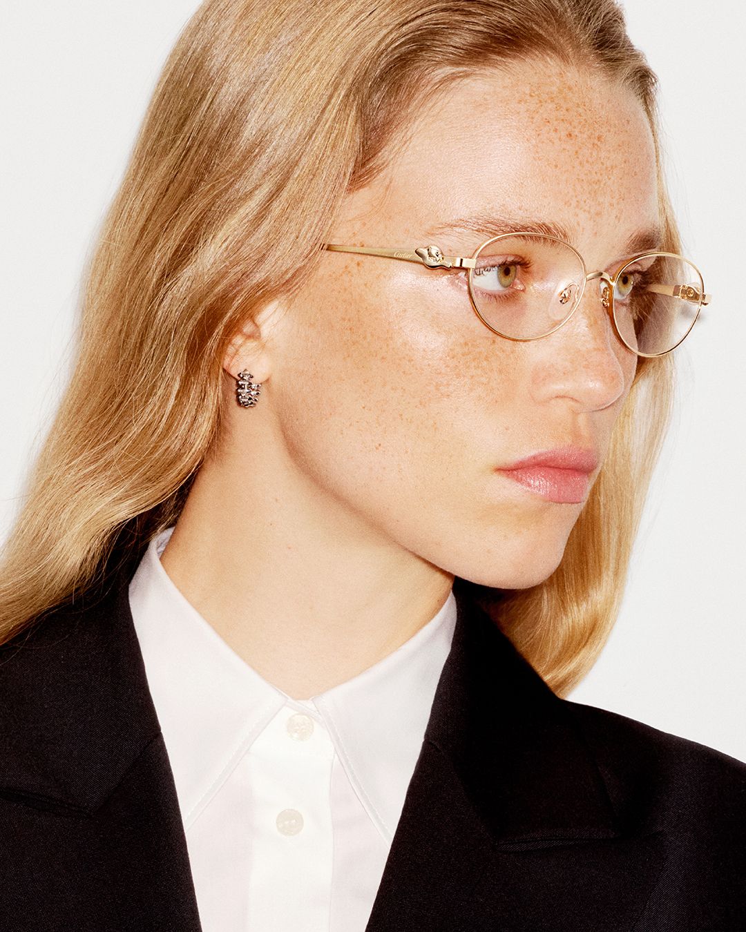 Model in gold round Cartier optical frames and a black blazer
