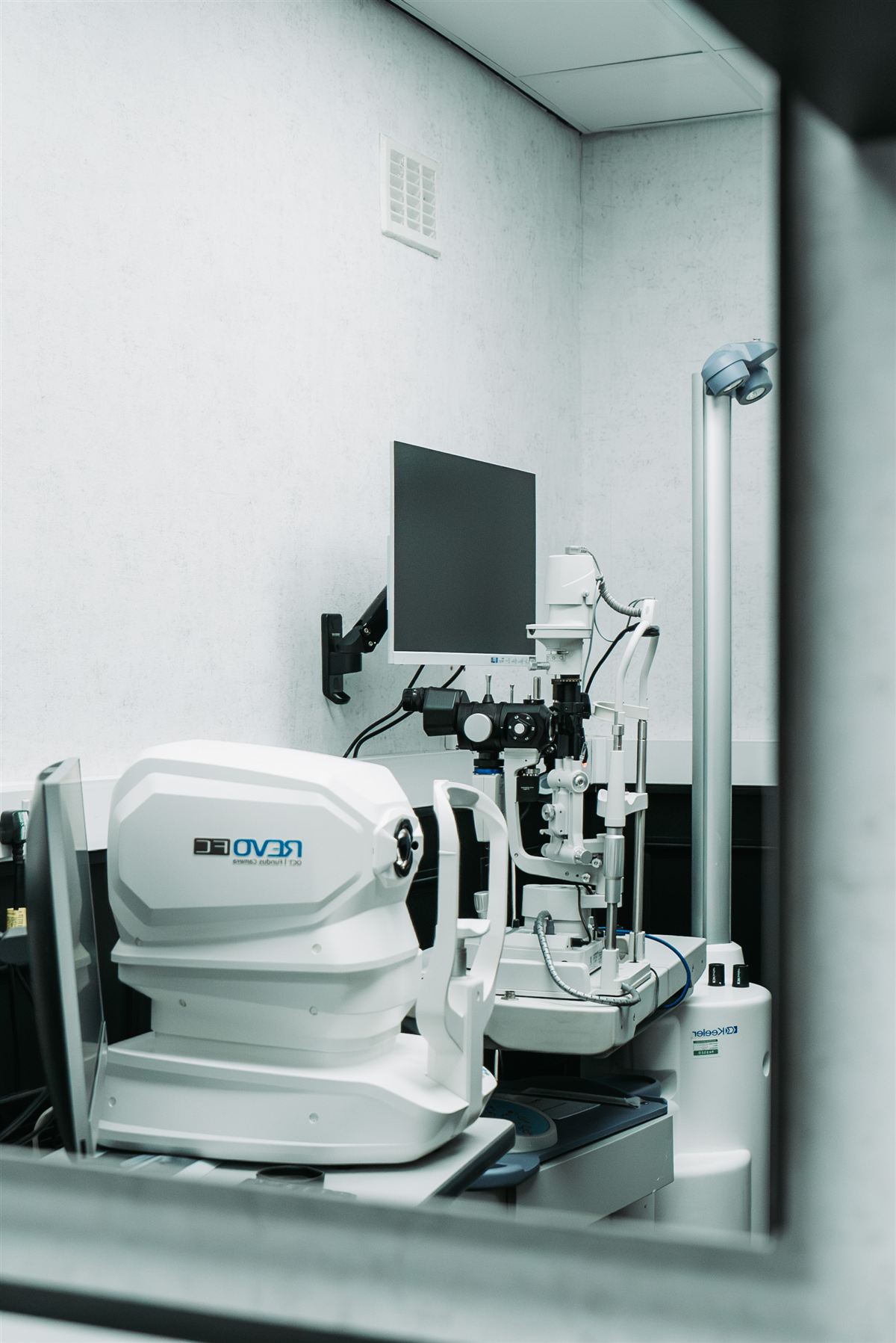 An optometrist examining the eyelids under magnification